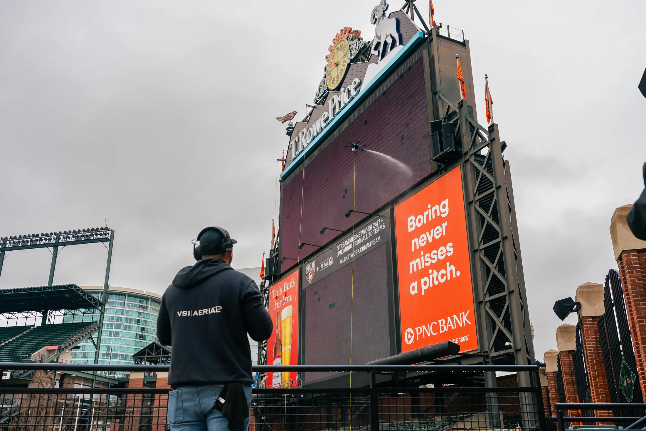 Cleaning drone working high on the scoreboard structure at a major-league ballpark